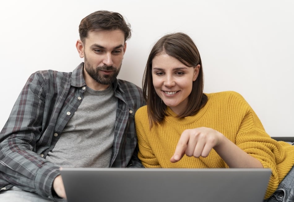 Pareja revisando en laptop un proyecto creado por una agencia de diseño de páginas web en Cholula y Puebla, mostrando satisfacción con el resultado.